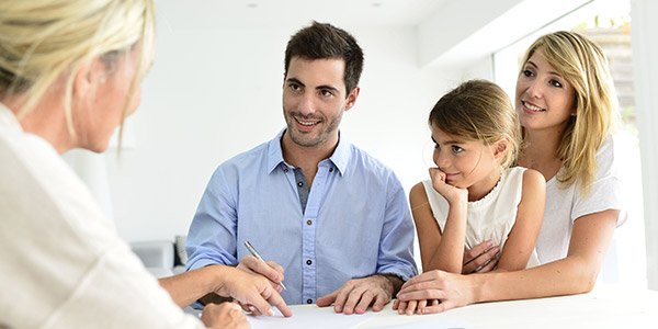 family going over paperwork with agent