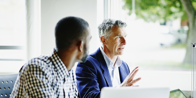 Businessman leading discussion with coworkers