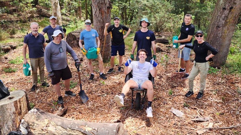 Photo of Vocus volunteers outside planting trees