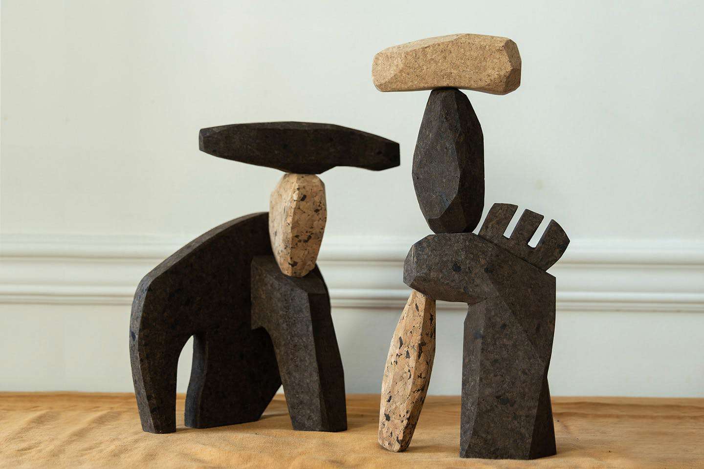 Photograph of Wallin’s cork remover and corkscrew cover are shown alongside other carved cork objects, arranged together as a sculptural tableau.