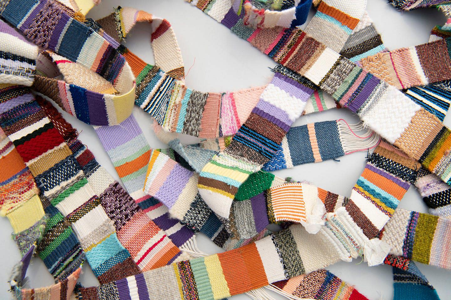 Woven belts on a table.