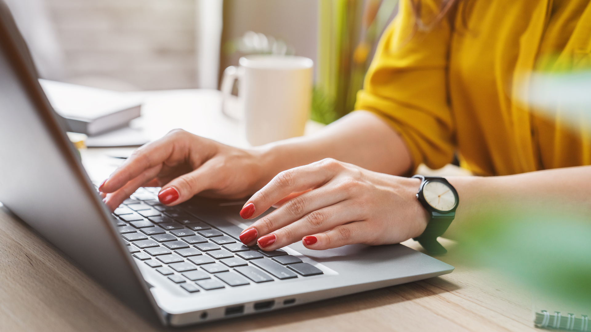 Cropped image of business woman hand working laptop computer in home office