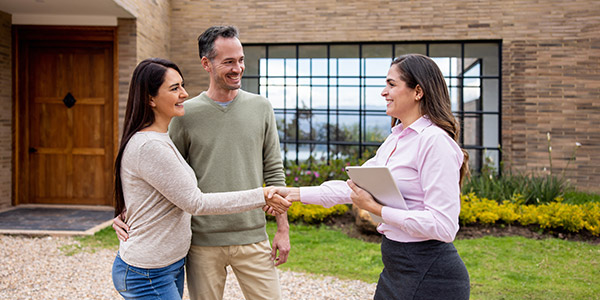 homebuyers shaking hands with a real estate agent