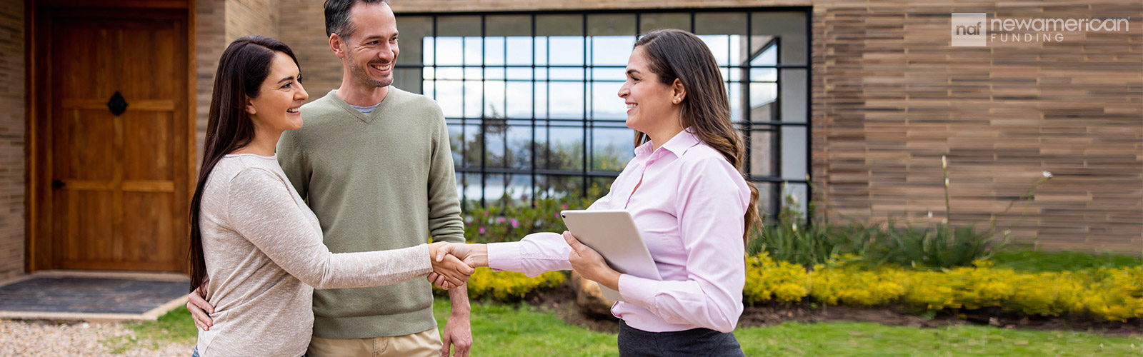 homebuyers shaking hands with a real estate agent