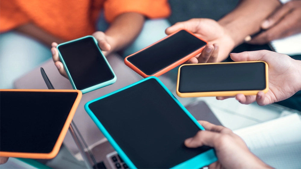 Stock image of hands holding mobile phones
