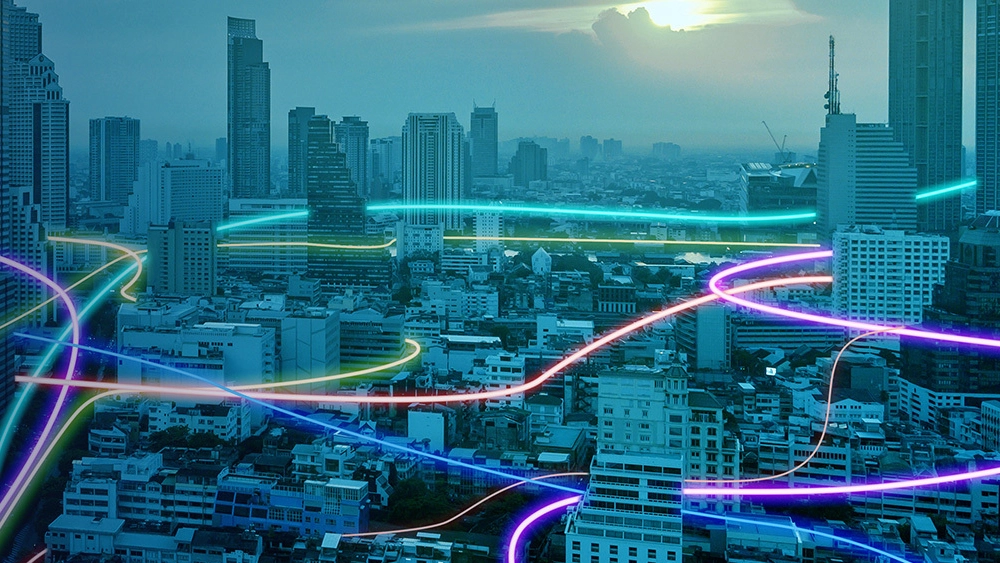 Stylised image of city with blue overlay and fluorescent lines connecting buildings representing the Vocus Network