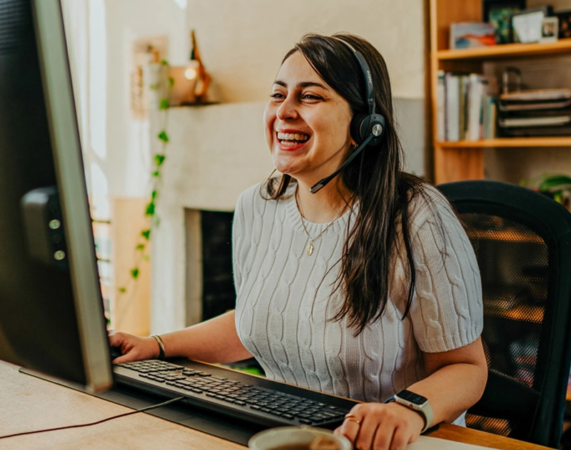 Picture of a Vocus female employee smiling and working from home