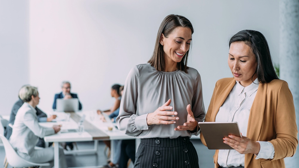 Stock image of Office workers looking at tablet
