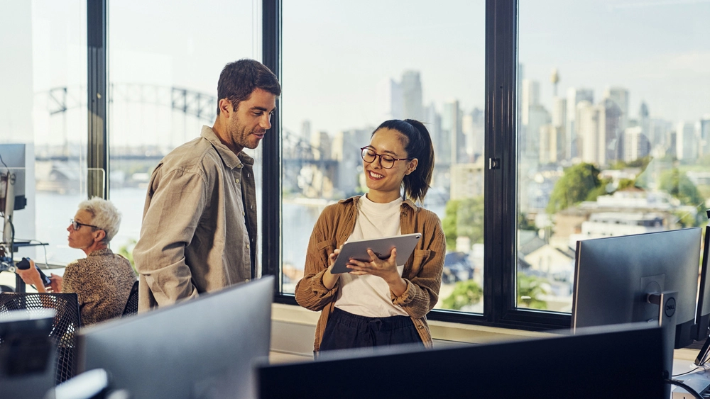 Stock image of Office workers looking at tablet