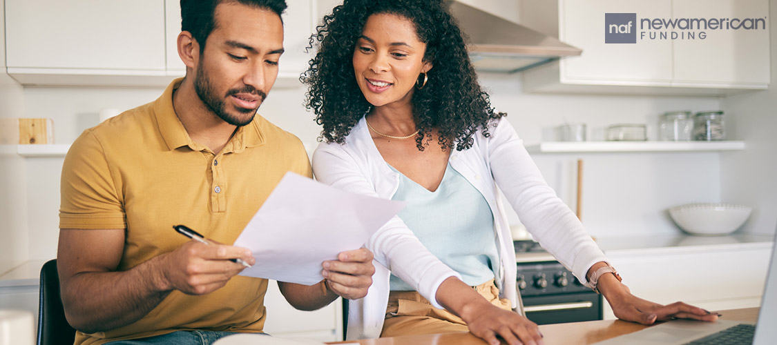 couple going over papwerwork in kitchen