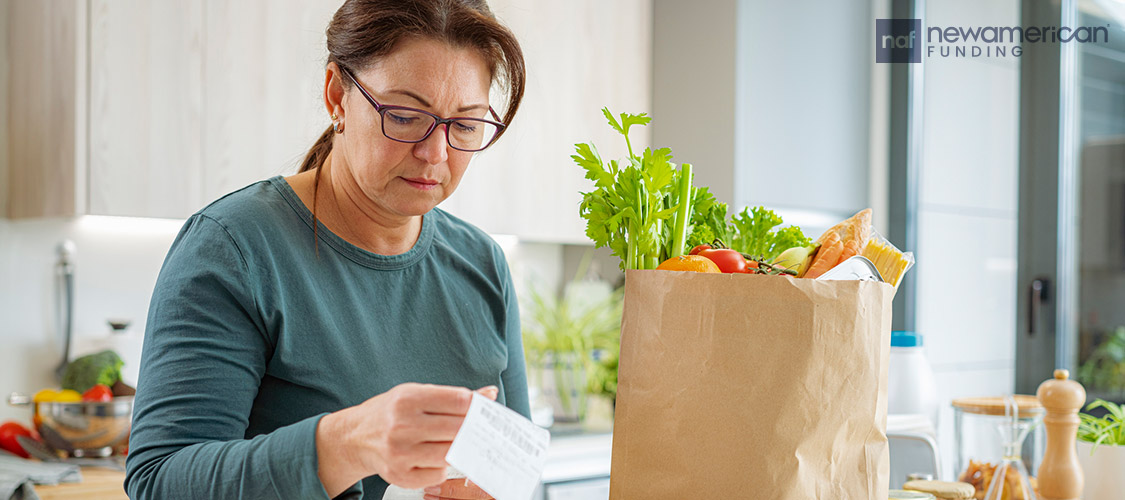 woman looking at grocery receipt