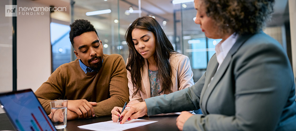 agent reviewing paperwork with clients