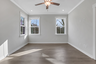 primary bedroom with hard surface flooring and ensuite bath