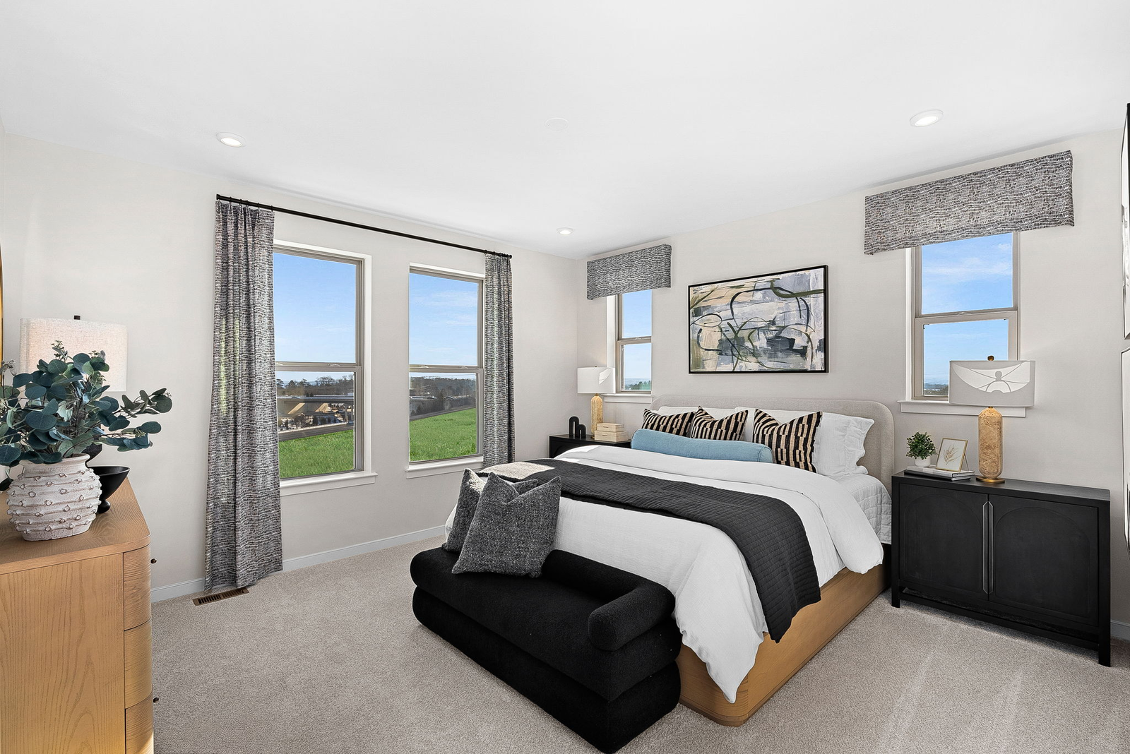 primary bedroom with carpet, large bedroom, and windows