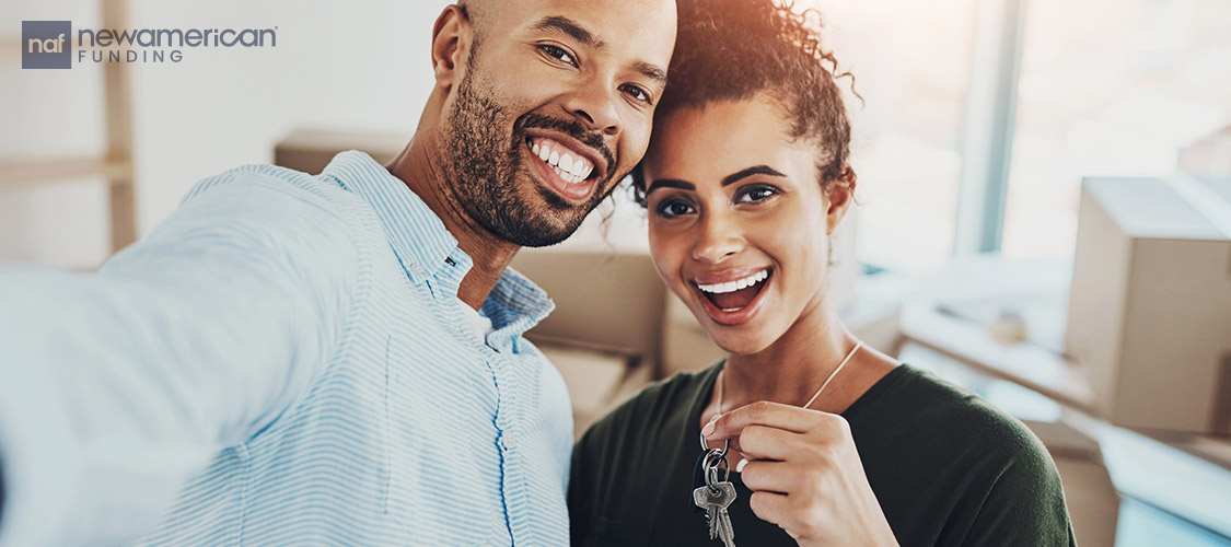 couple holding keys to new home