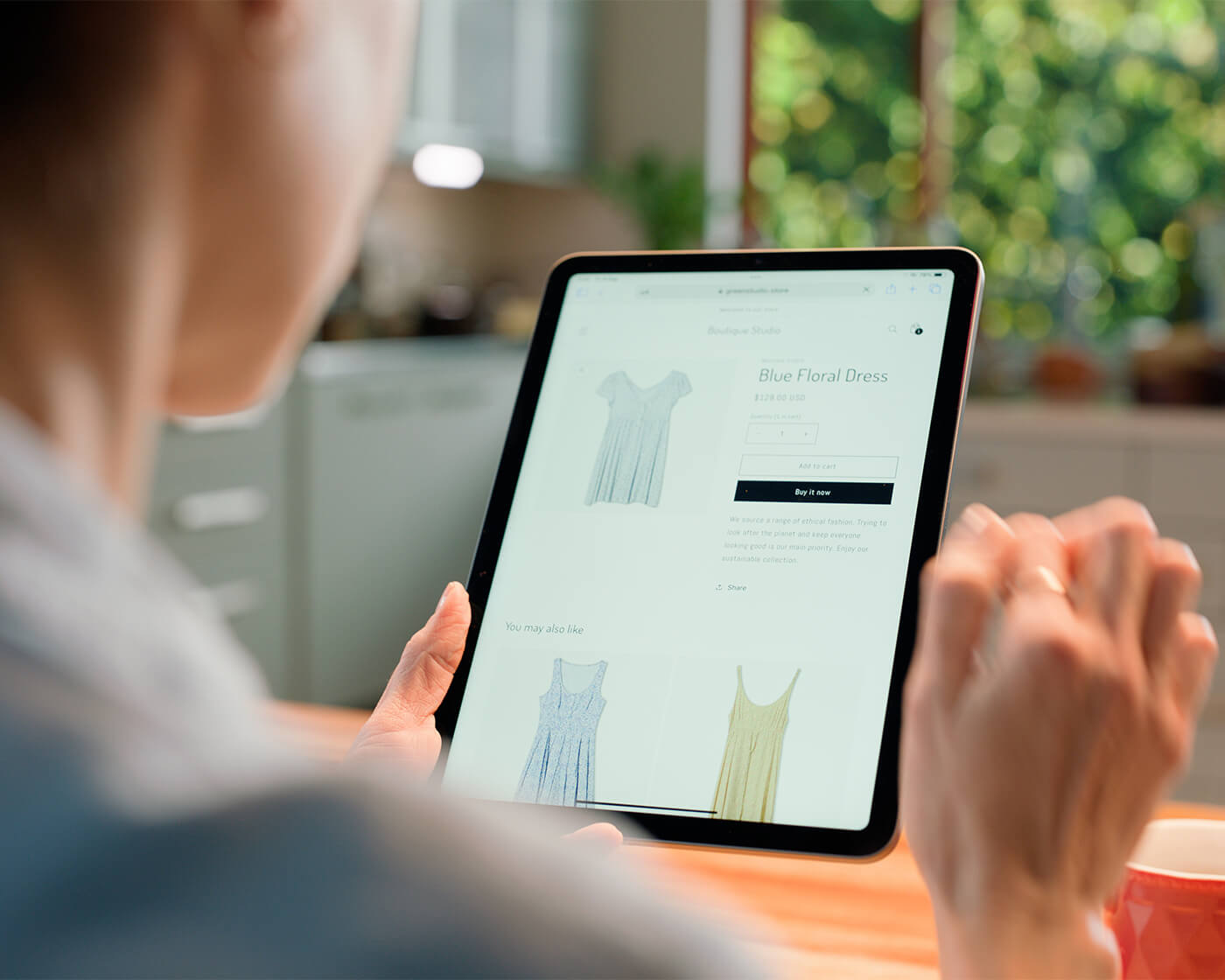 Woman holding an electronic tablet.