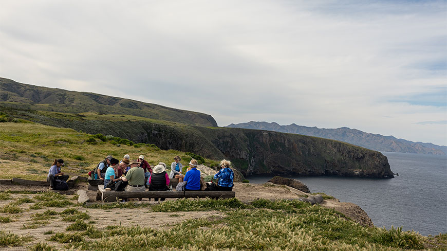A group sits on benches at a scenic overlook on Santa Cruz Island in California’s Channel Islands National Park.