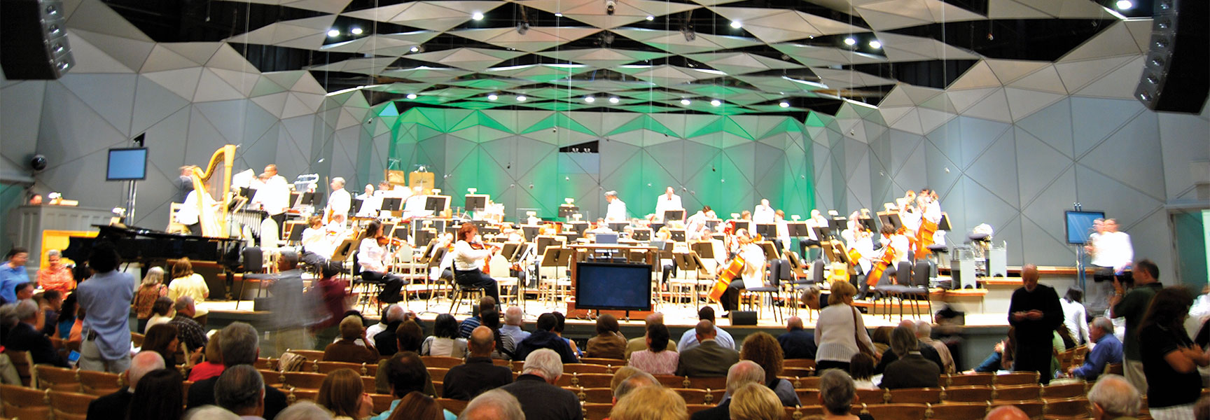 The Boston Symphony Orchestra performs for an audience in the modern Tanglewood Theatre in Massachusetts.