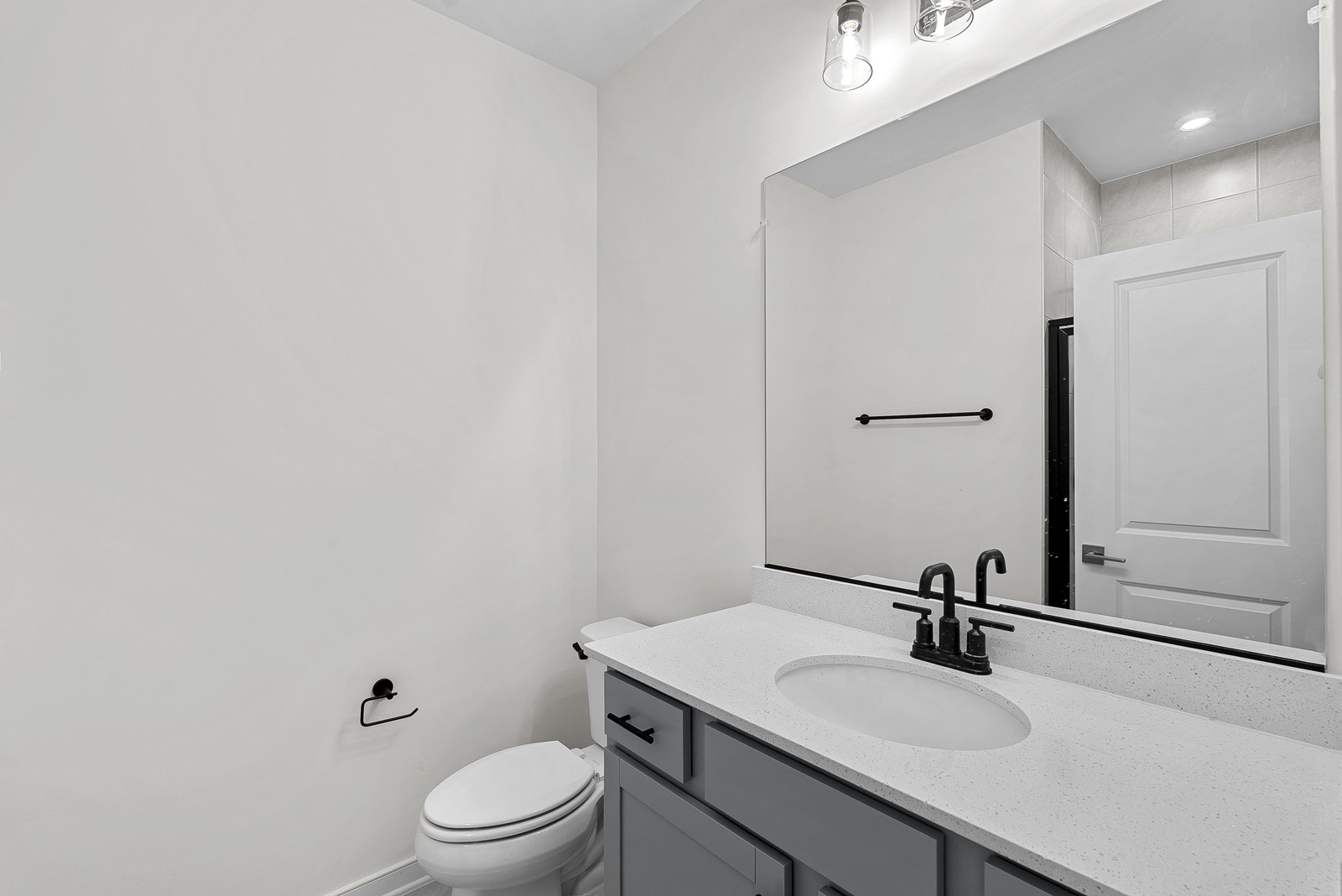 vanity sink and mirrors and toilet