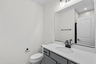 vanity sink and mirrors and toilet