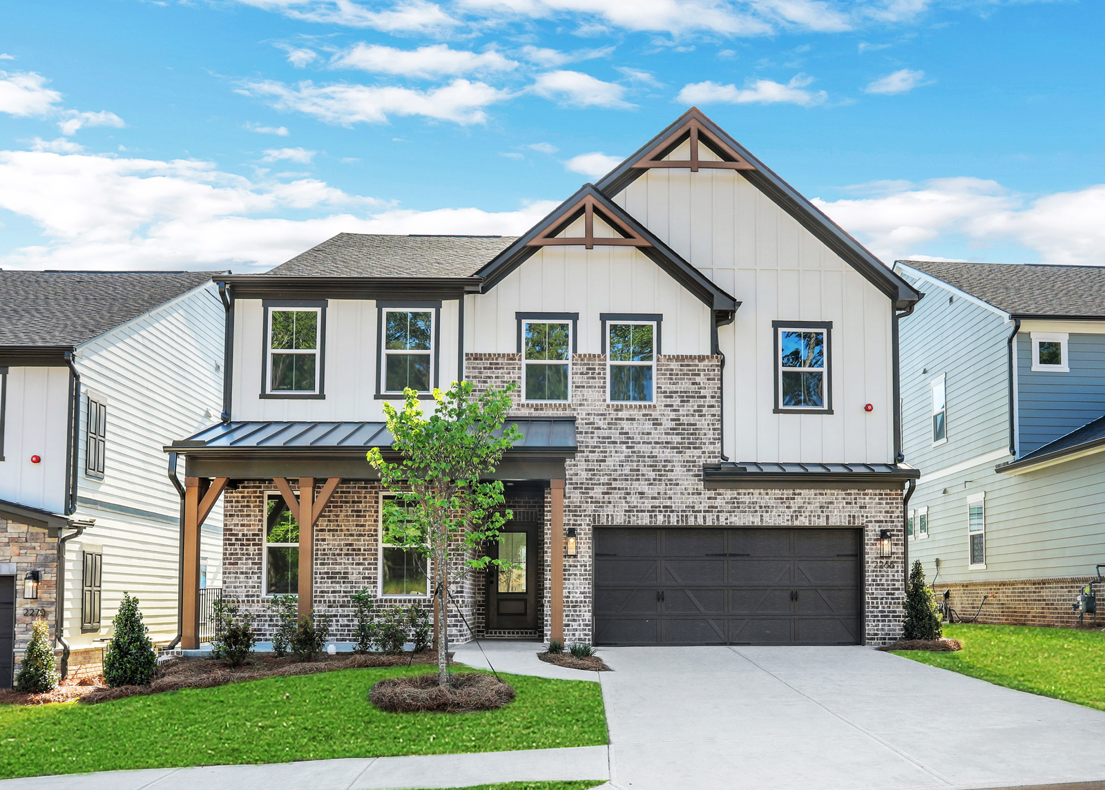 front of 2-story home with light siding and dark accents