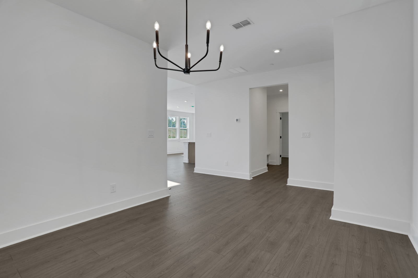 dining room with hard surface flooring and matte black light fixture