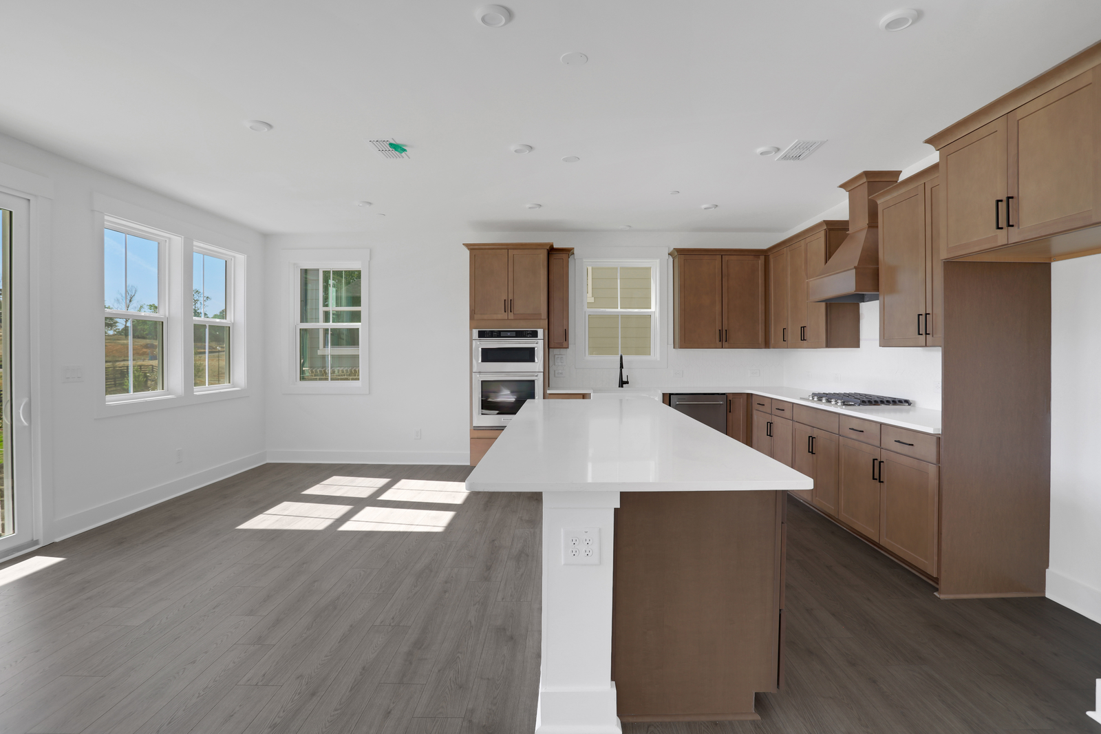 kitchen with wood-finish cabinets and white quartz counters