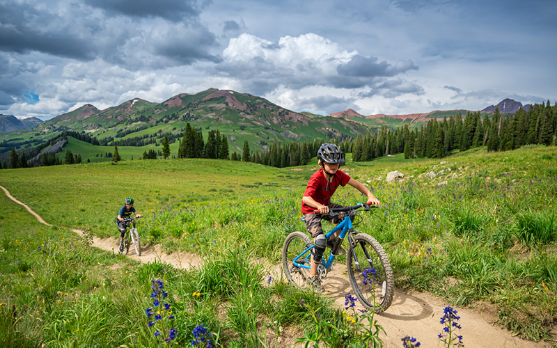 A group of people riding bikes on a trail