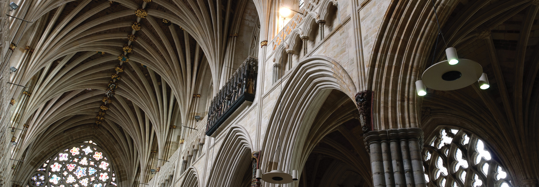The ornate, vaulted stone ceiling and Gothic arches inside a historic cathedral in Cornwall, England.