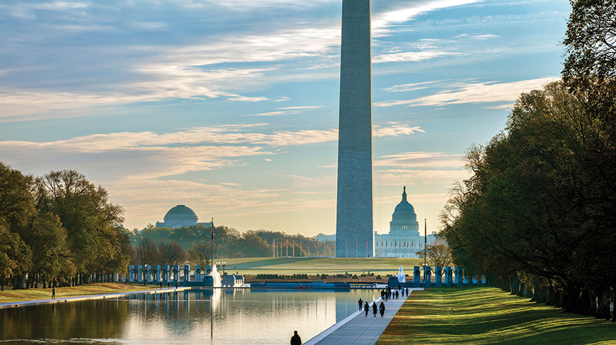 The Washington Monument and U.S. Capitol are seen across the Reflecting Pool on the National Mall in Washington, D.C., during the day.