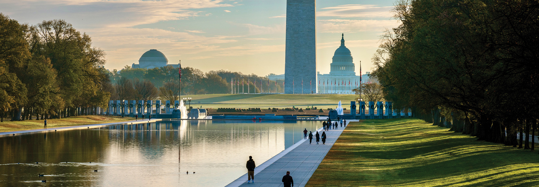 An early morning view of the National Mall in Washington, D.C., with the Reflecting Pool, Washington Monument, and U.S. Capitol building.