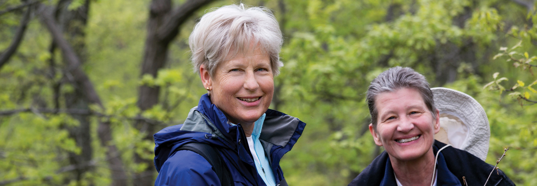 Two women smile while hiking on the Appalachian Trail in Pennsylvania.