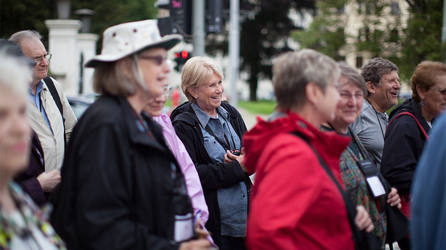 Carol Kraus laughing with a group of people at a center in Prague.