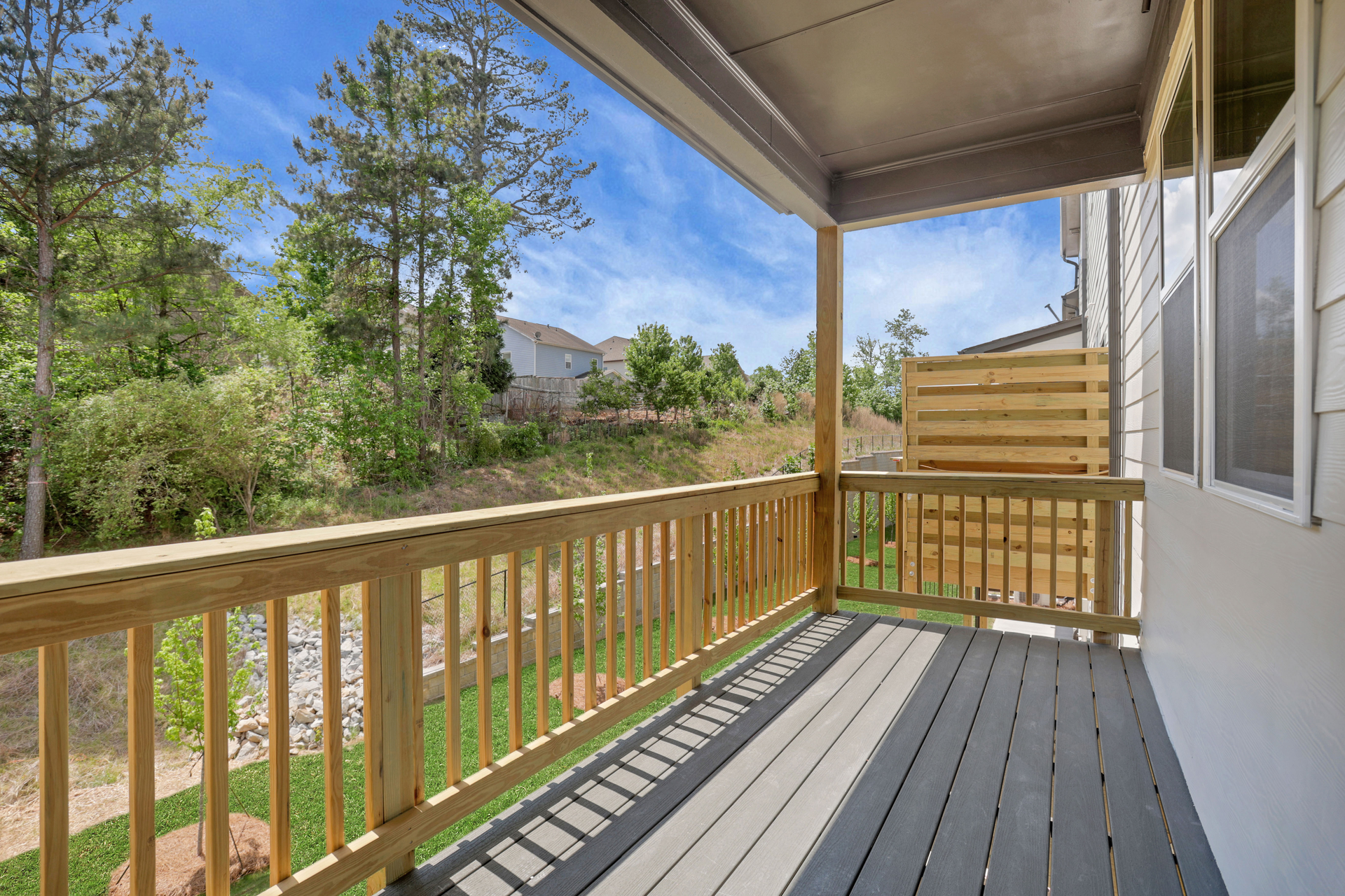 covered deck off of the great room with view of backyard