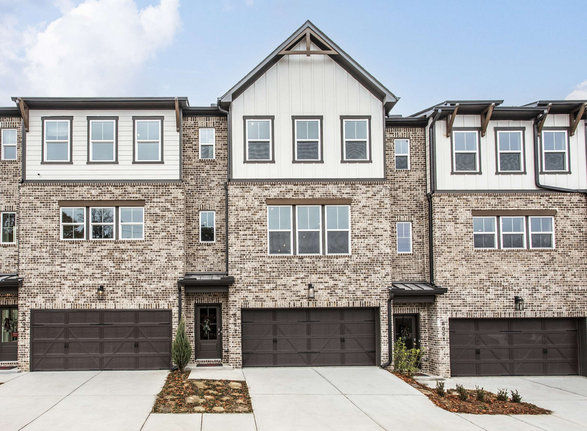 front of 3-story townhome with brick and dark accents