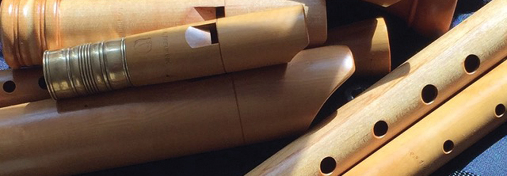A close-up of several wooden recorders piled together for the National Road Scholar Early Music Workshop in Carmel Valley.
