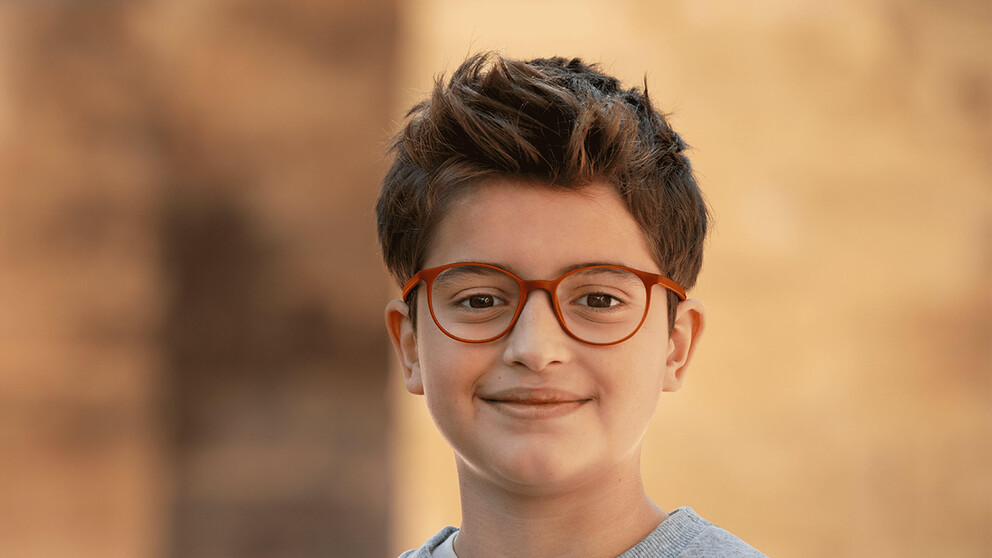 Smiling boy wearing HOYA MiYOSMART glasses