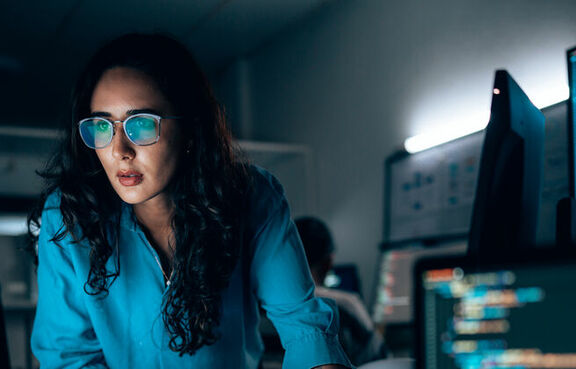 IT woman monitoring computer screens