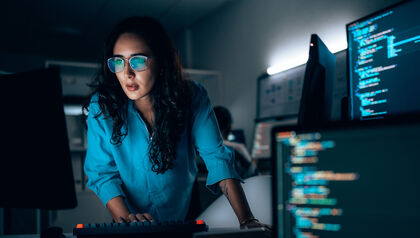 IT woman monitoring computer screens