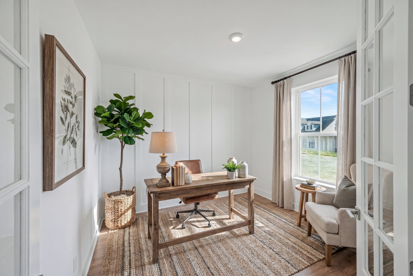 study with wood flooring, accent wall, desk and chair, windows, and curtains