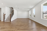 great room with oak wood staircase, and large windows
