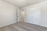 secondary bedroom with large windows and carpet