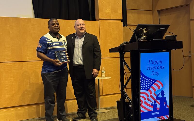 Chief Pathology Officer James Pepoon presented Retired Air Force Major Barney Morris, a prostate cancer survivor and Moffitt advocate, with a plaque in appreciation for his 20 years of service.   