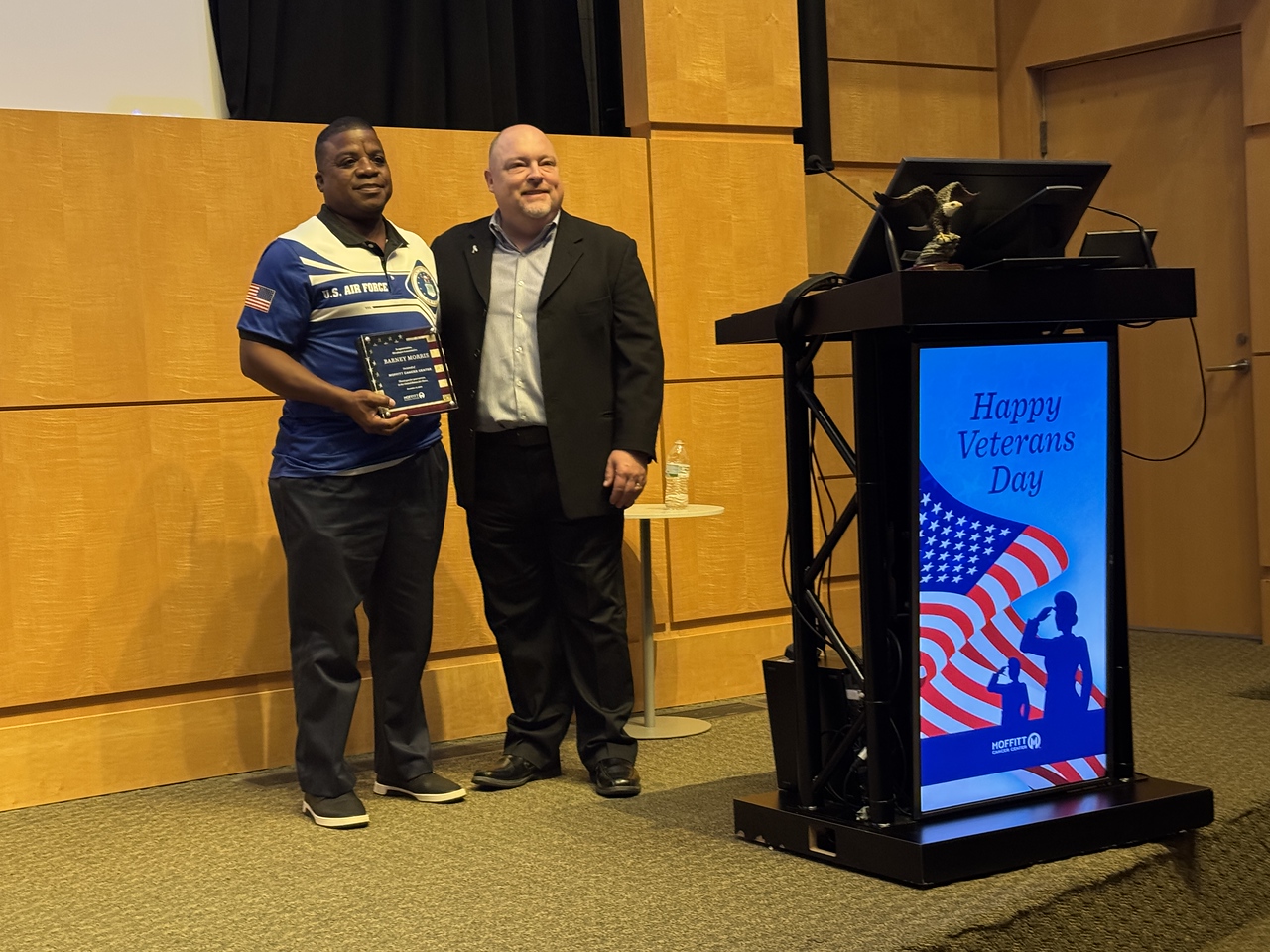 Chief Pathology Officer James Pepoon presented Retired Air Force Major Barney Morris, a prostate cancer survivor and Moffitt advocate, with a plaque in appreciation for his 20 years of service.   