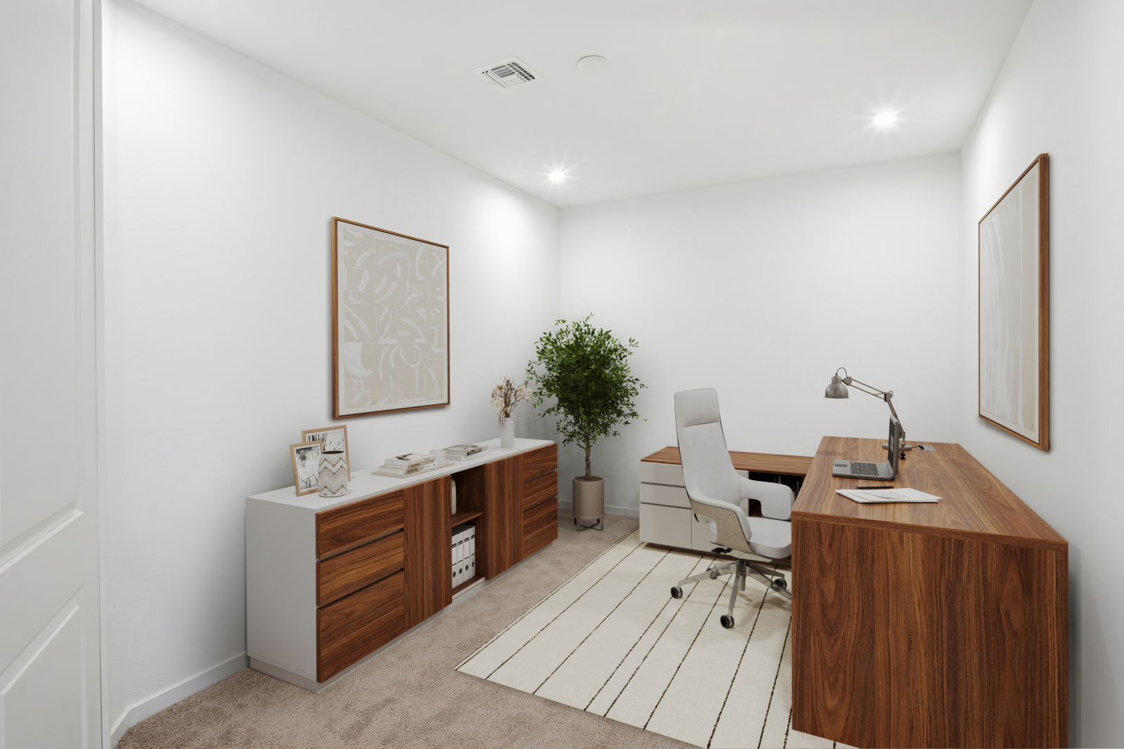 at home office with a large brown wooden desk, white office chair, and white rug