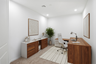 at home office with a large brown wooden desk, white office chair, and white rug