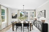dining table with carpet and hardwood floors underneath, windows to deck