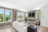 room with carpet and hardwood floors, fireplace, sofa and chairs