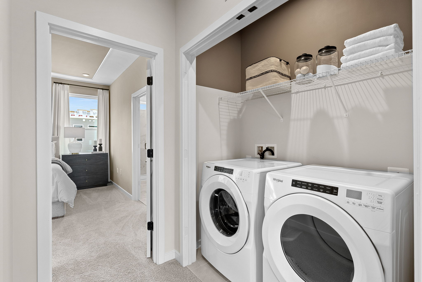 open laundry closet with a white washer and dryer,