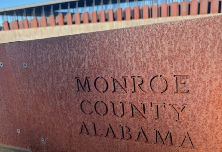 "Monroe County Alabama" is etched on a steel monument at the National Memorial for Peace and Justice